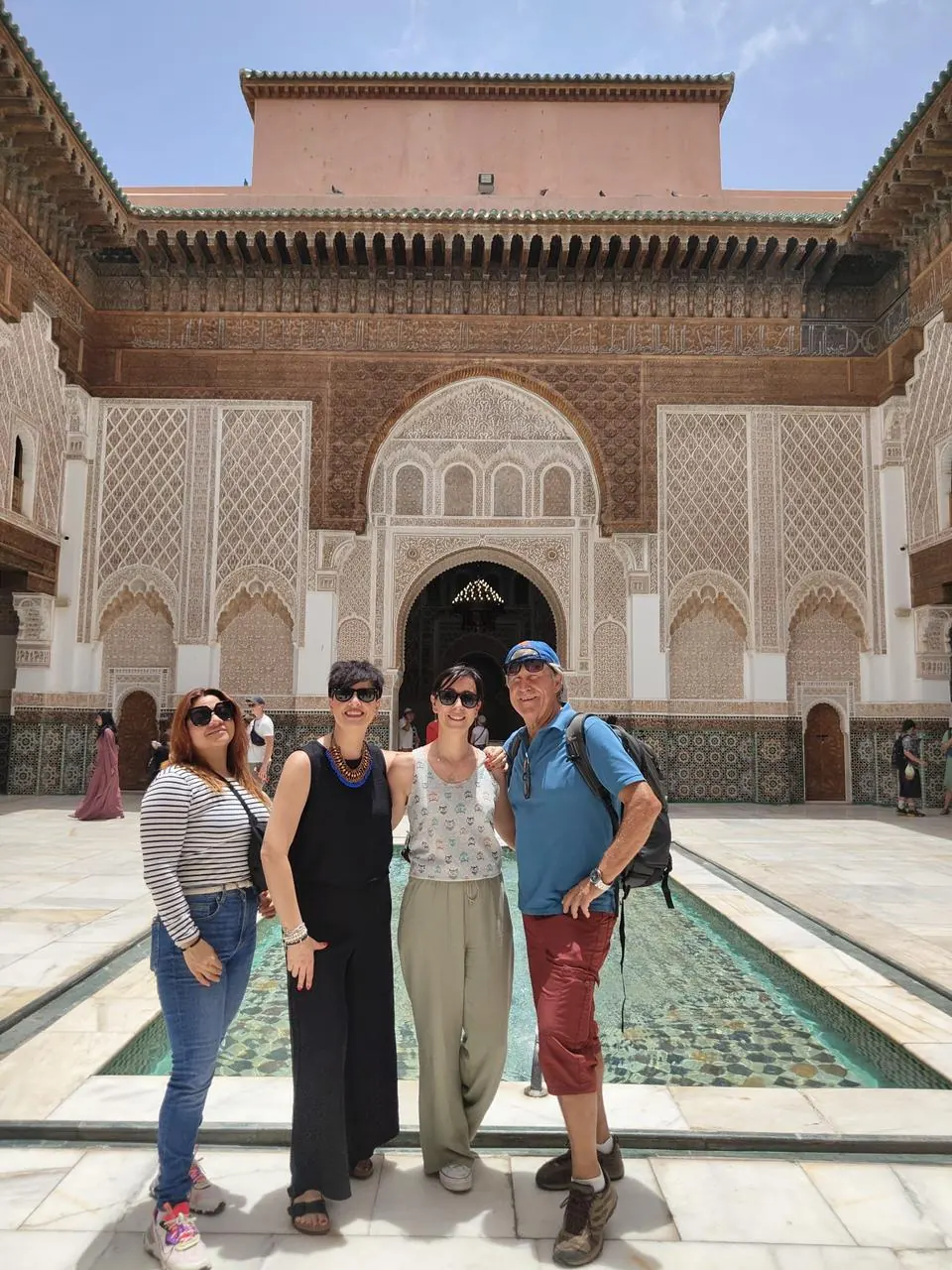 Travelers visiting the courtyard of Ben Youssef Madrasa in Marrakech
