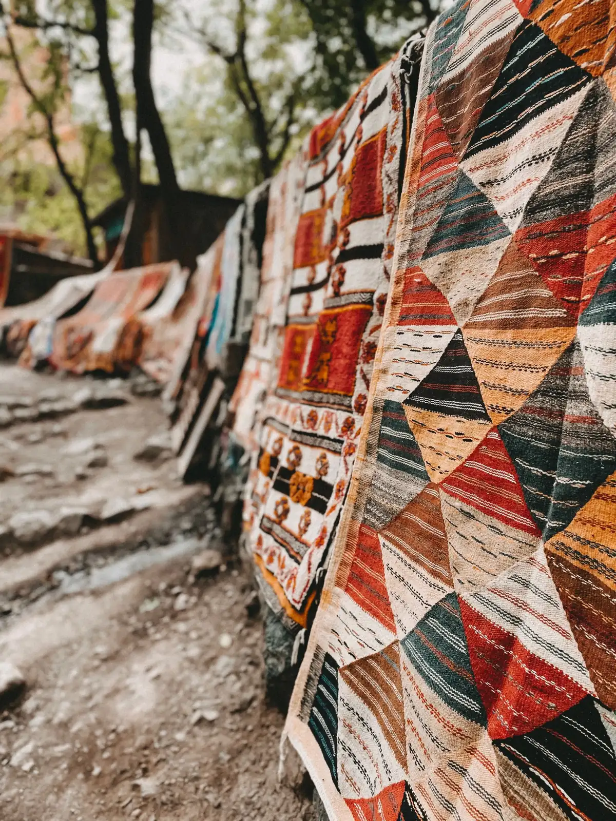 Patterned rugs hanging outdoors in an Atlas Mountains village