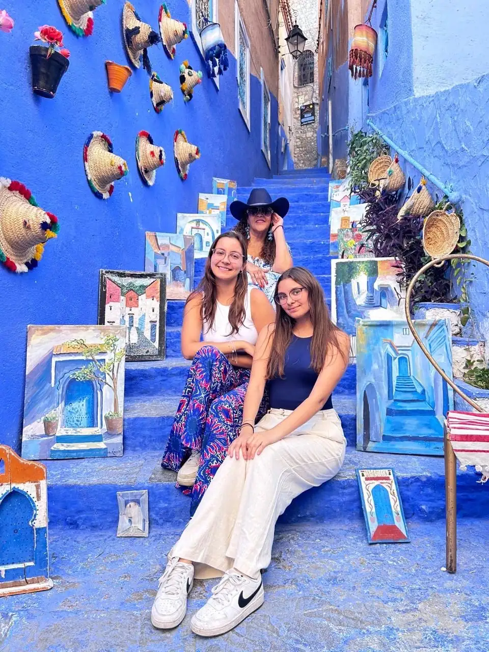 Travelers on blue-painted steps in Chefchaouen