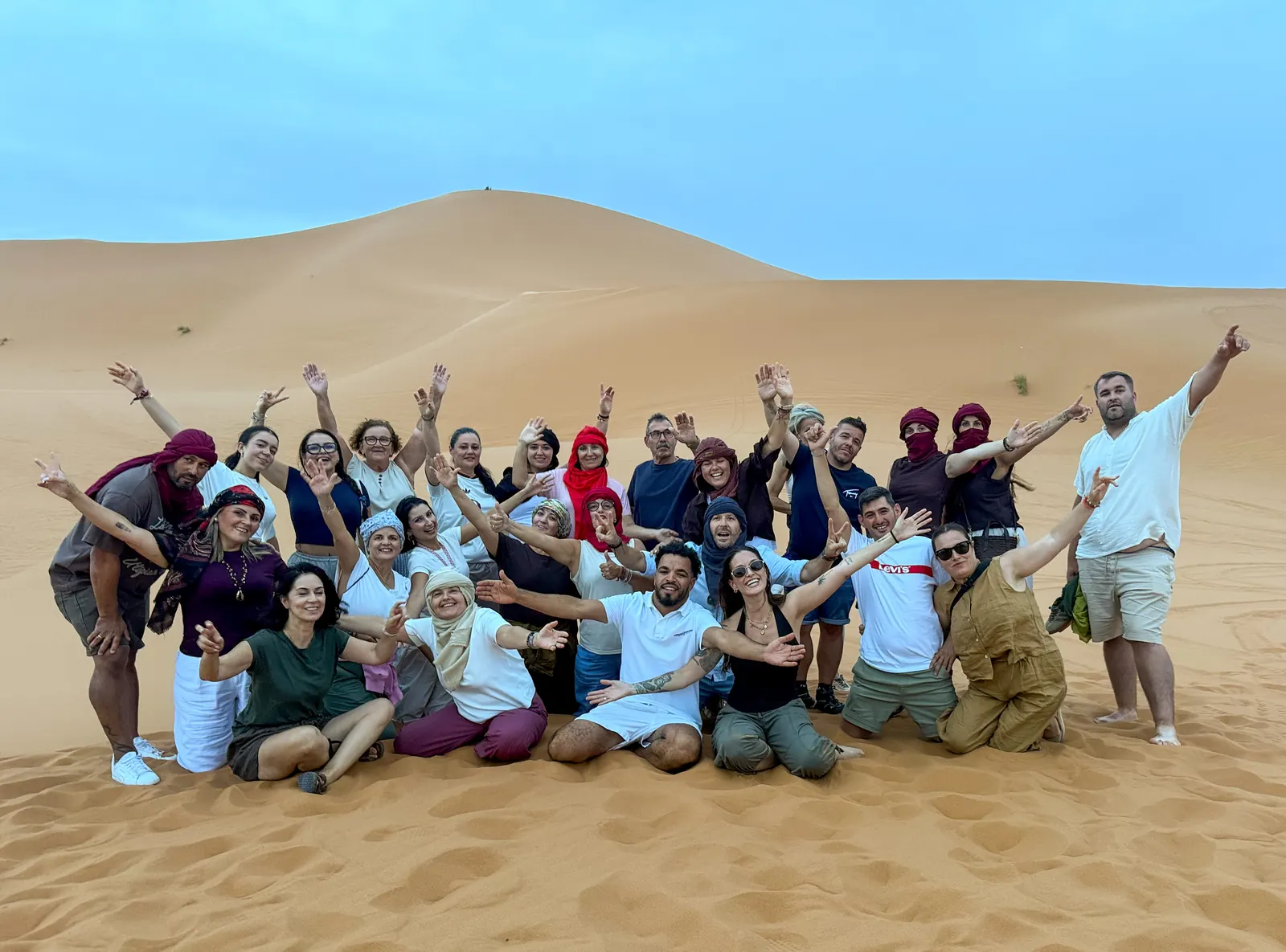 Complete Morocco guides and travelers together in the Erg Chebbi dunes near Merzouga