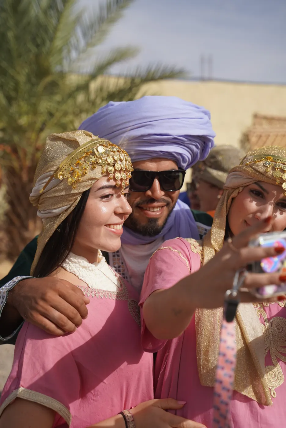 Guide and travelers in traditional Amazigh dress near Merzouga