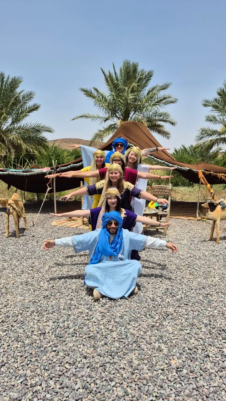 Travelers sharing a cultural visit near Merzouga